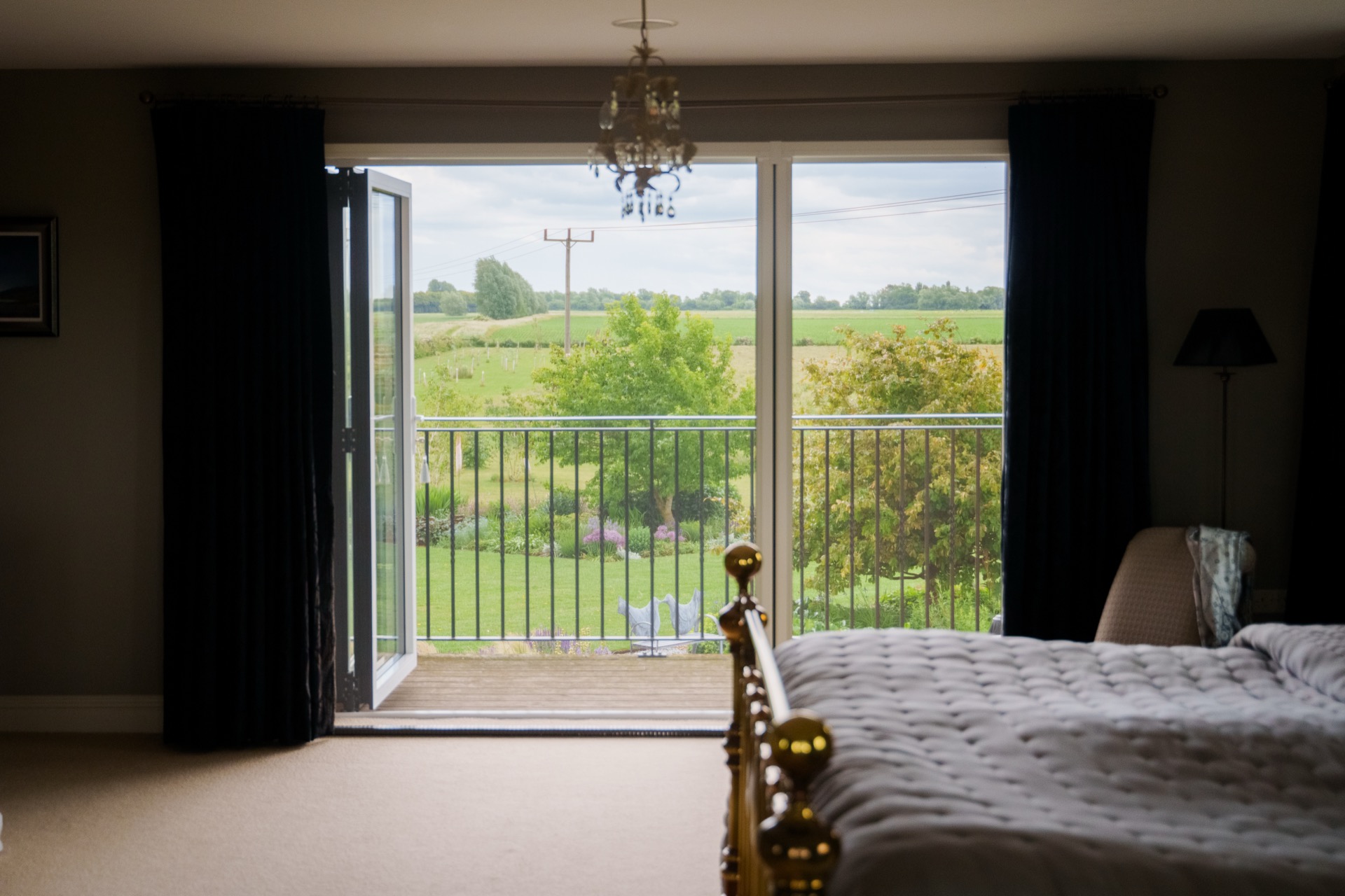 Open bi-fold doors with fly screens, countryside beyond